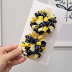 Par de pompons escolares