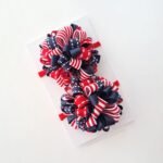 Par de pompons escolares