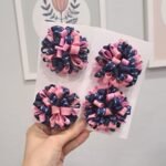 Par de pompons escolares