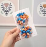 Par de pompons escolares